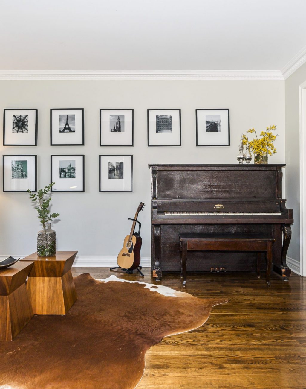 Bright sitting room with wood floors and upright piano.